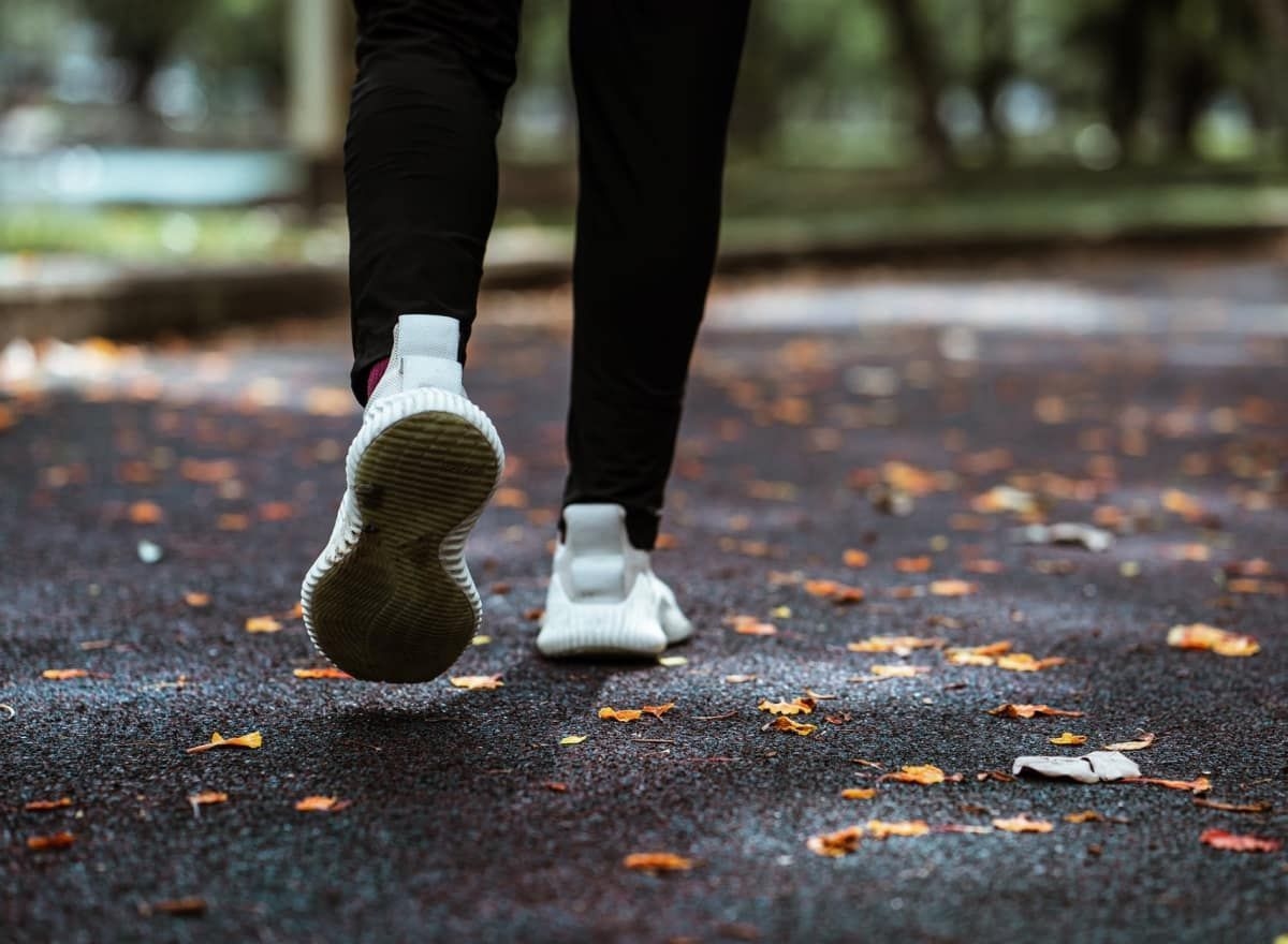 picture of persons legs walking in white shoes