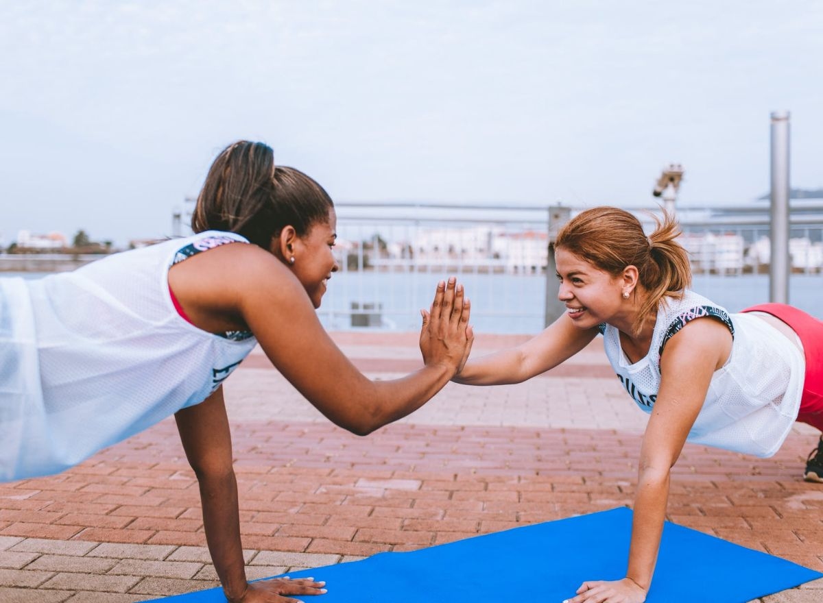 Two people doing pushups while hi-fiving