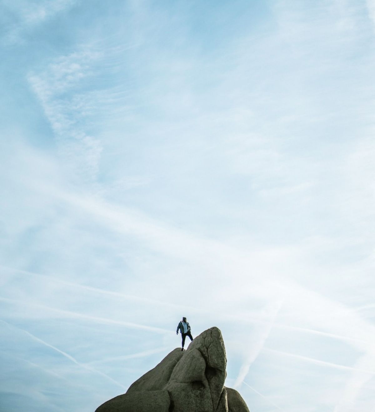 Person standing on top of a rock