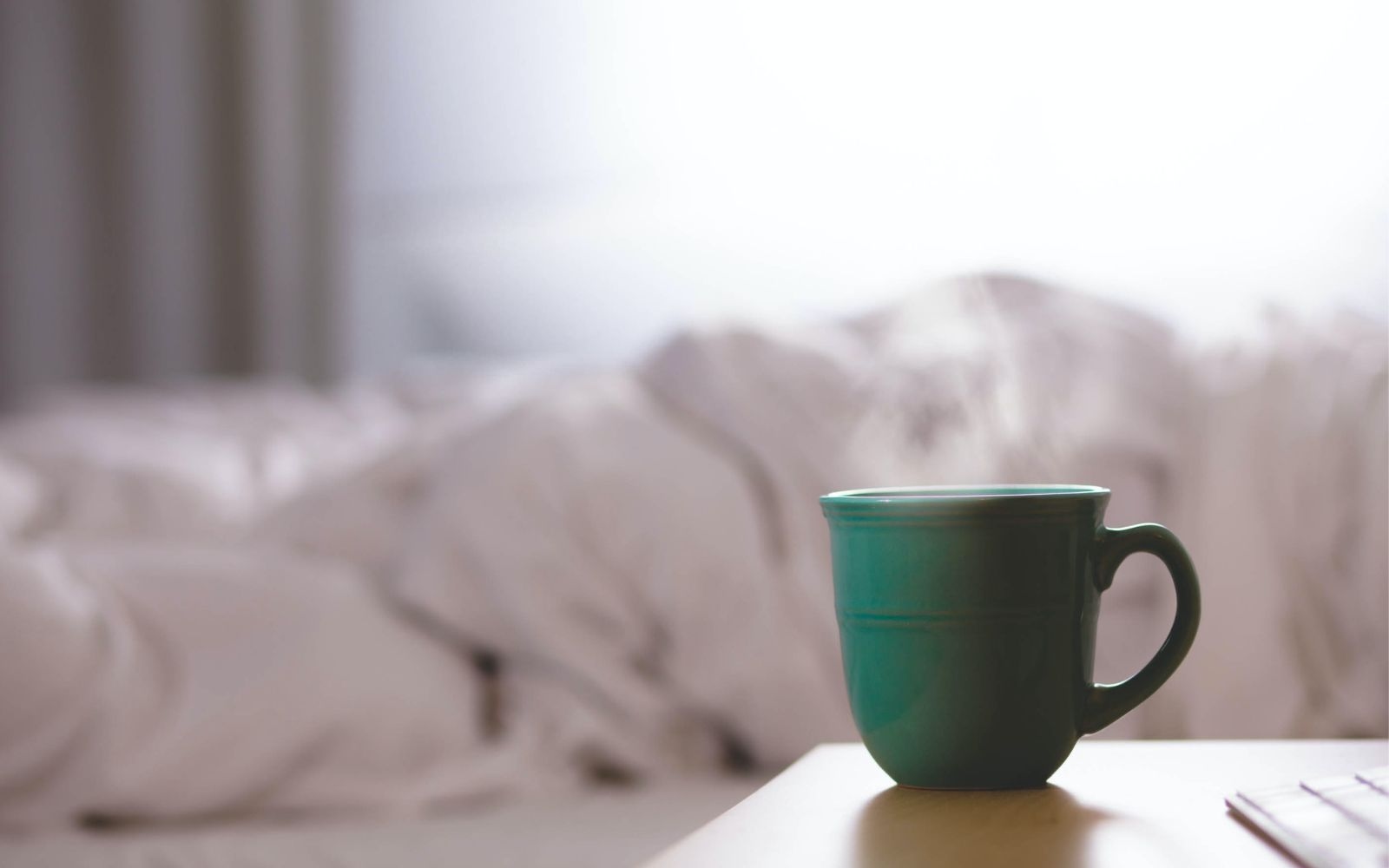 coffee cup steaming on a table