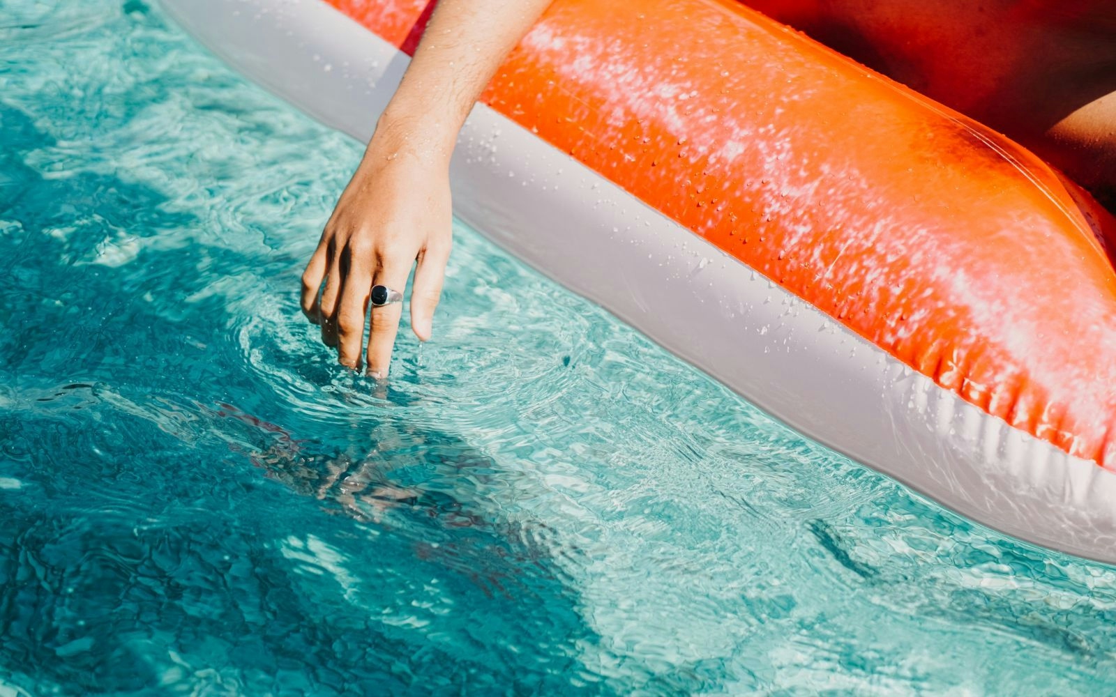 person floating on water float in pool